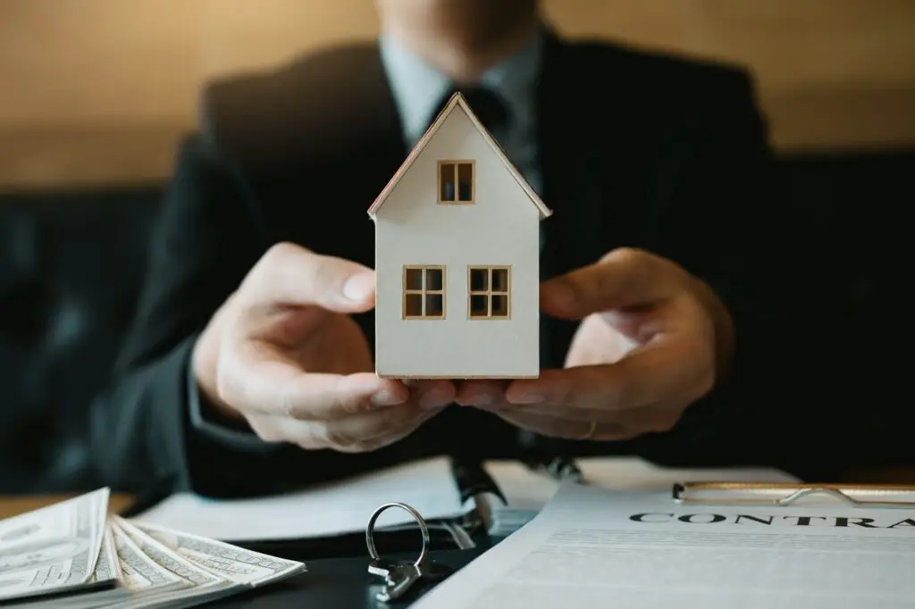 real estate sales staff give the artificial home to customers